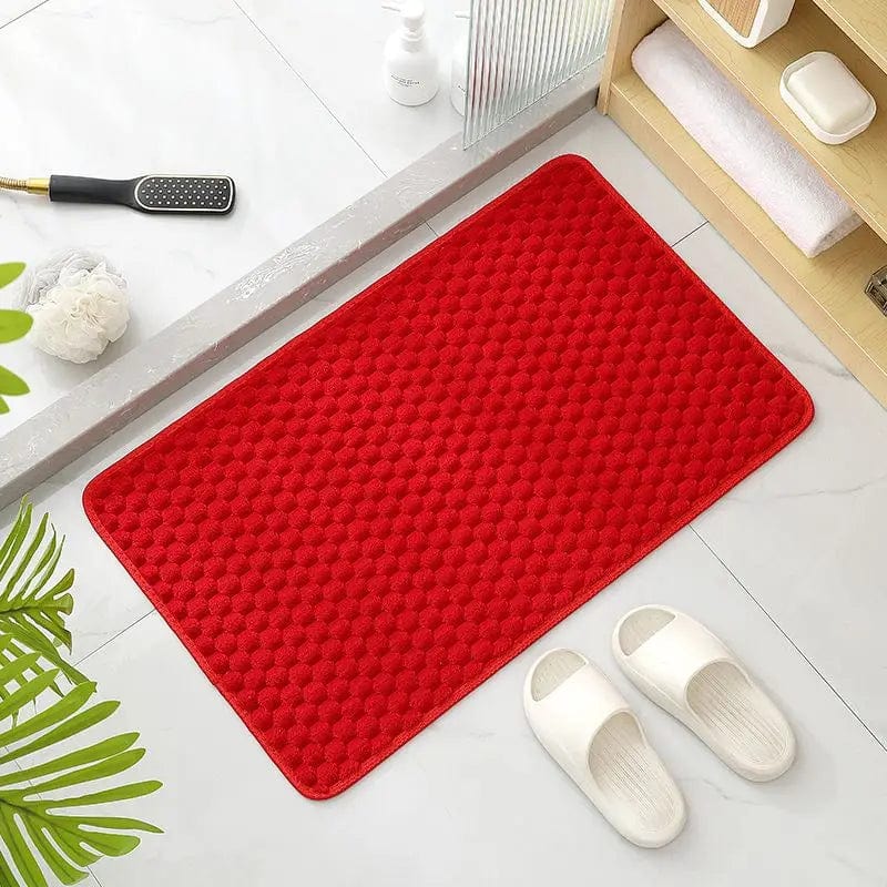 Rode antislip badmat met textuur voor badkamer.