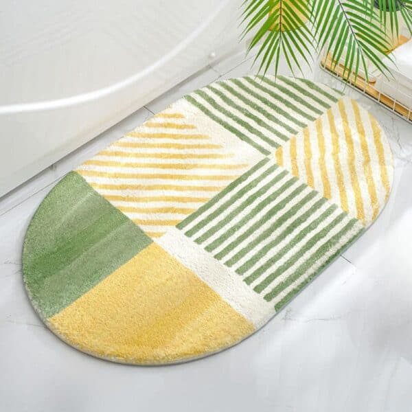Ovale badmat anti-slip met groene en gele strepen.