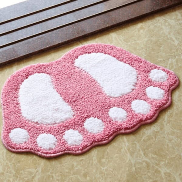 Voetvormige badmat in roze met witte details voor badkamer.