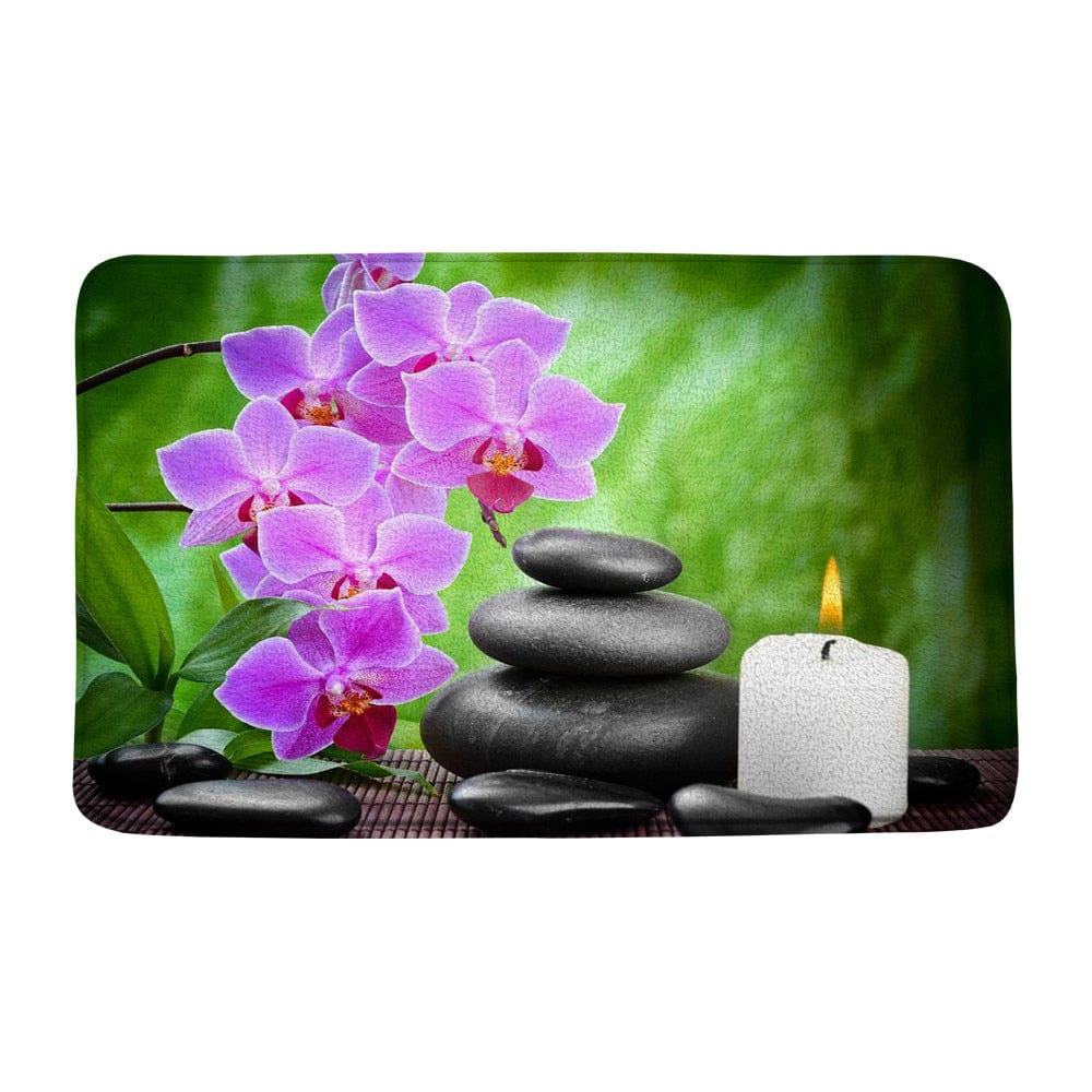Zen badmat met orchideeën, stenen en kaars voor ontspanning.