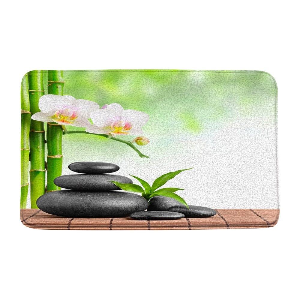 Zen badmat met bamboe, orchidee en stenen voor ontspanning.