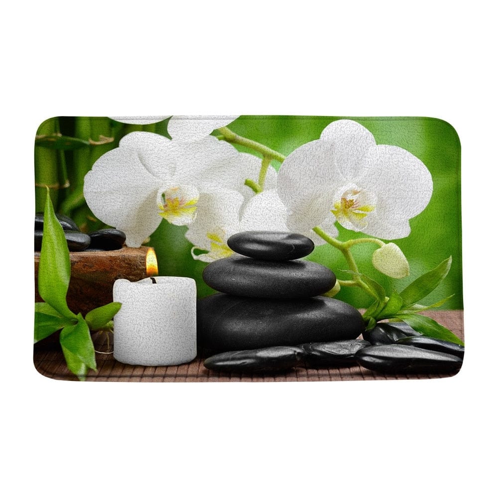Zen badmat met witte orchideeën en zwart gestapelde stenen voor ontspanning.