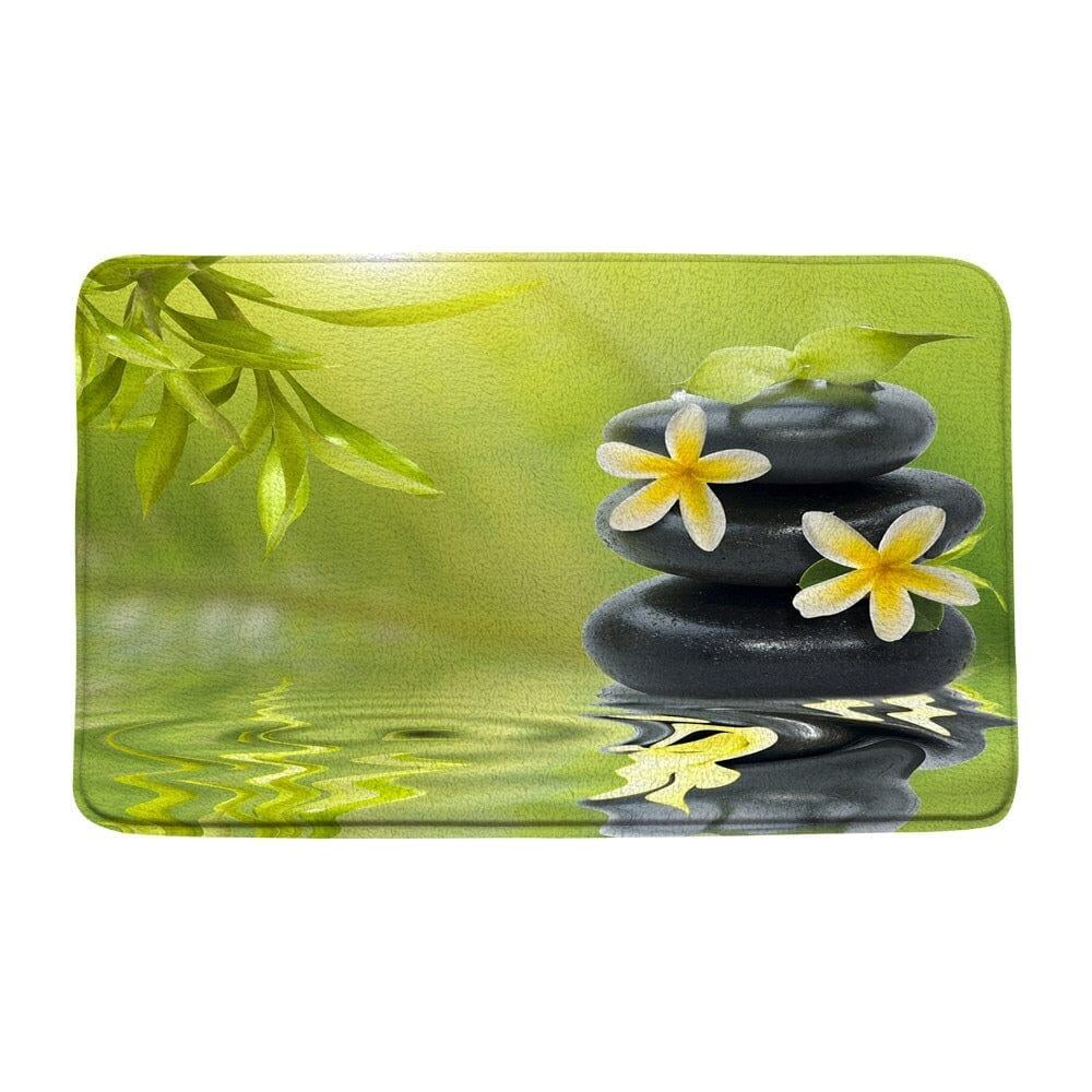 Zen badmat met stenen en bloemen voor ontspanning.