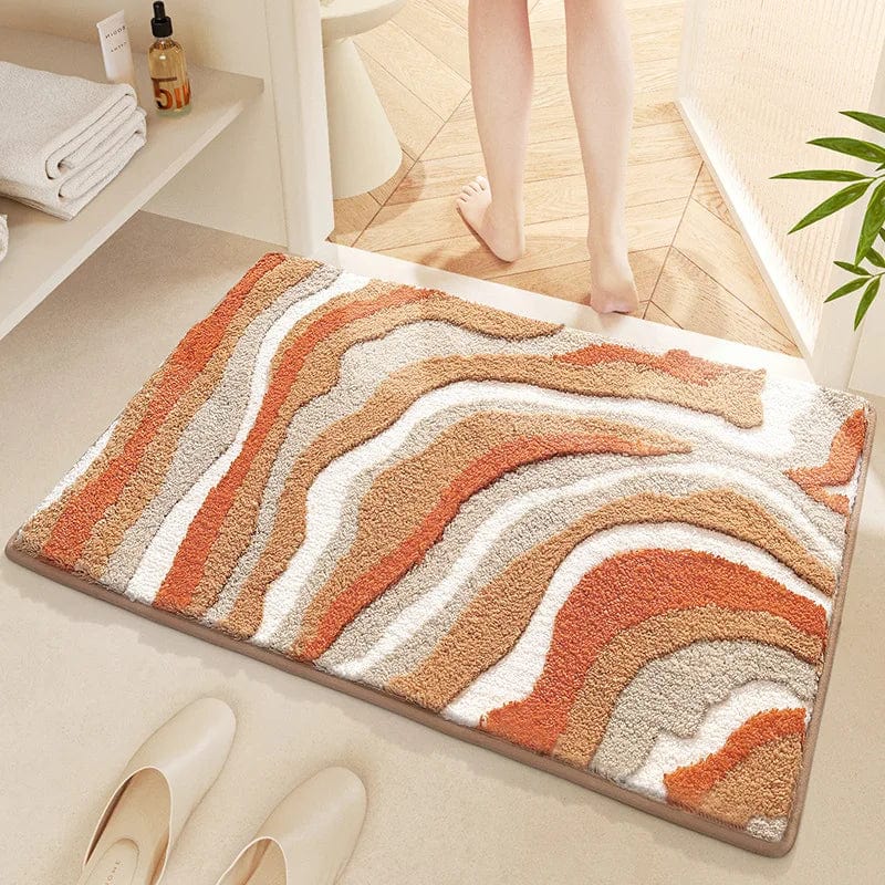 Badmat met golfpatroon in warme kleuren voor badkamer.