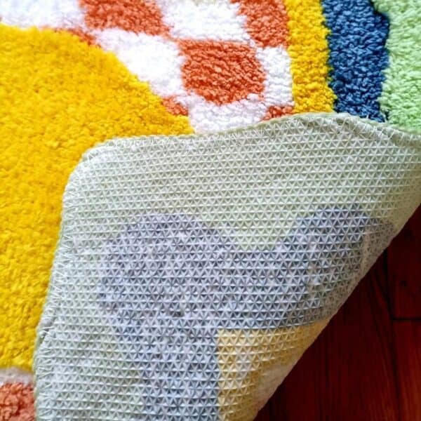 Citrus Art badmat met kleurrijke patroon en textuurrijke onderkant.