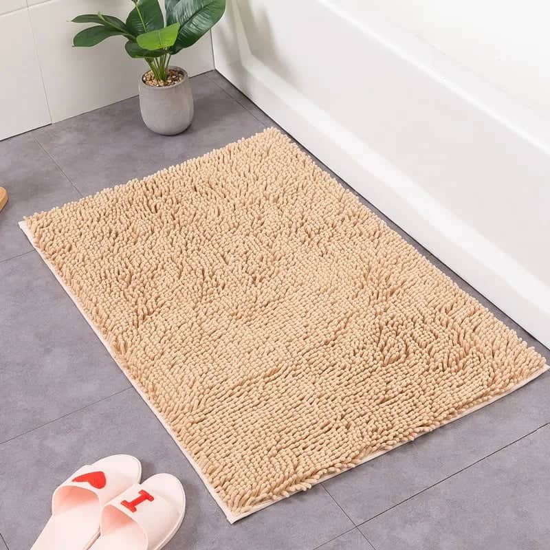 60x90 beige fluffy bath mat beside bathtub.