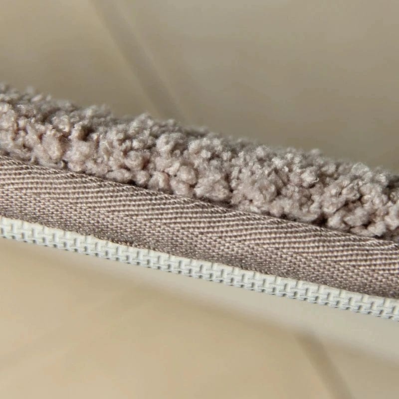 Absorbent bath mat close-up showing textured pile and stitched edge.