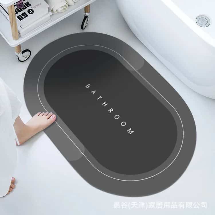 Anti-slip bathroom mat with 'BATHROOM' text, modern grey oval design.