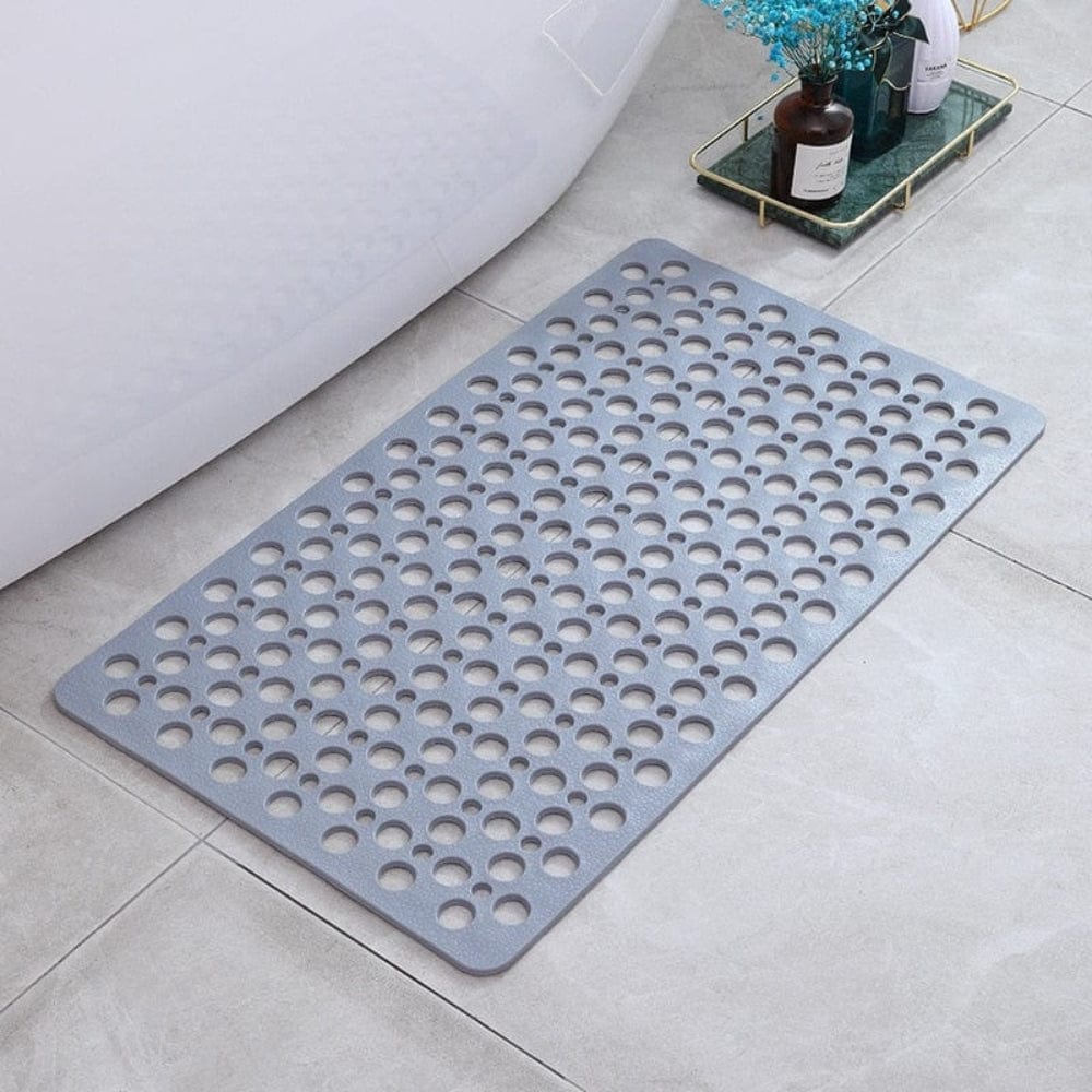 Gray bath massage mat with perforated design for drainage and comfort.