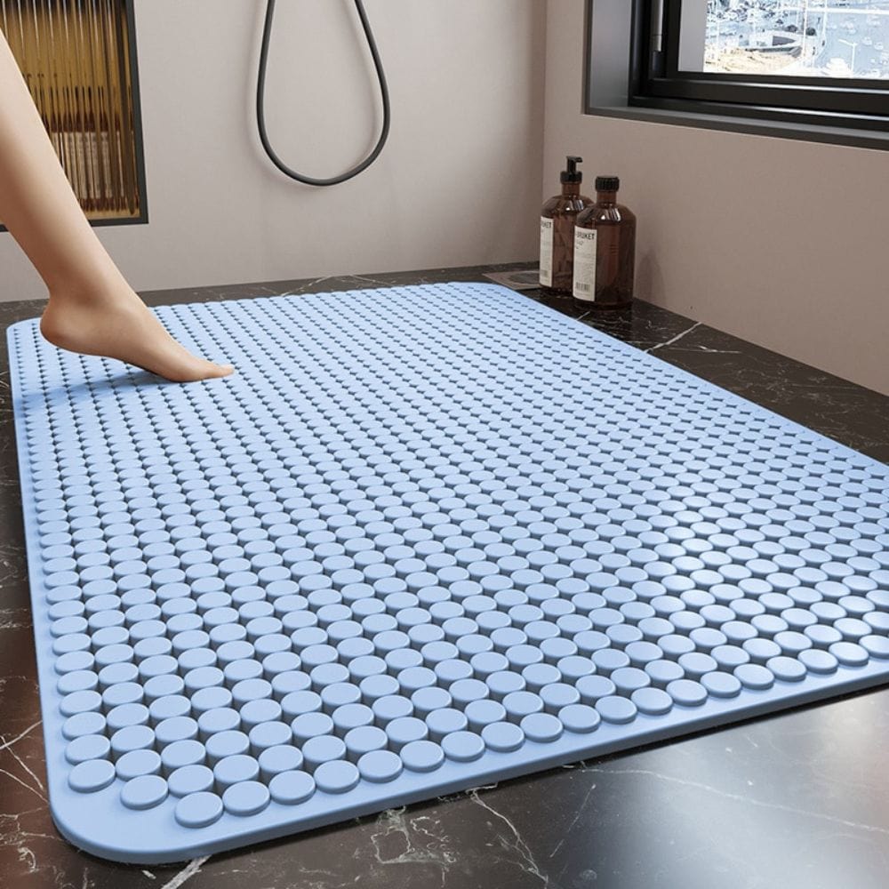 Blue textured bath mat for shower floor, non-slip and comfortable.