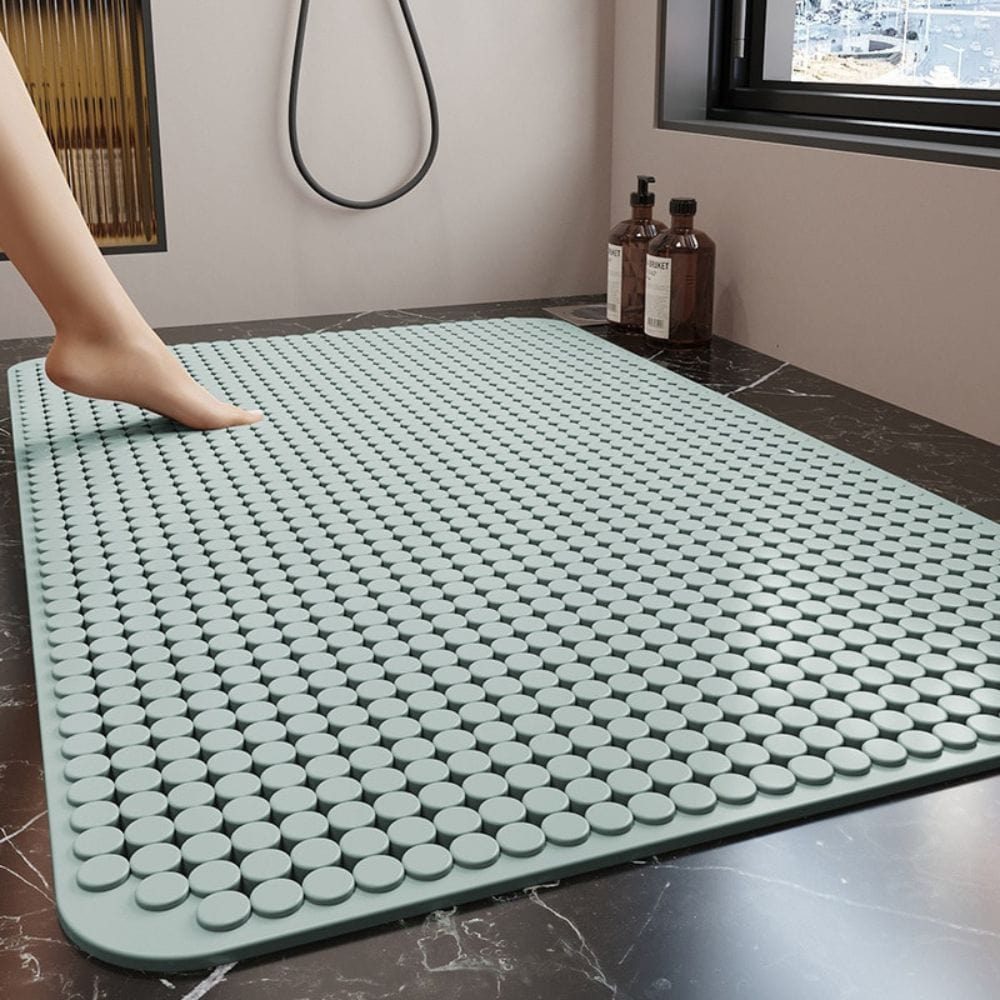 Anti-slip shower floor mat with textured dots for bathroom safety.