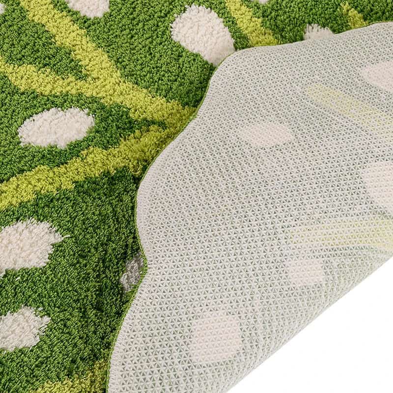 Green leaf pattern bath mat with textured backing.
