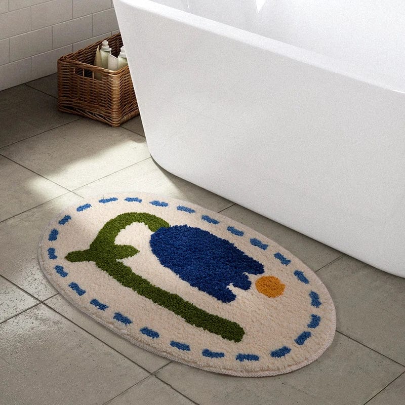 Round bath mat with blue flower design for bathroom.