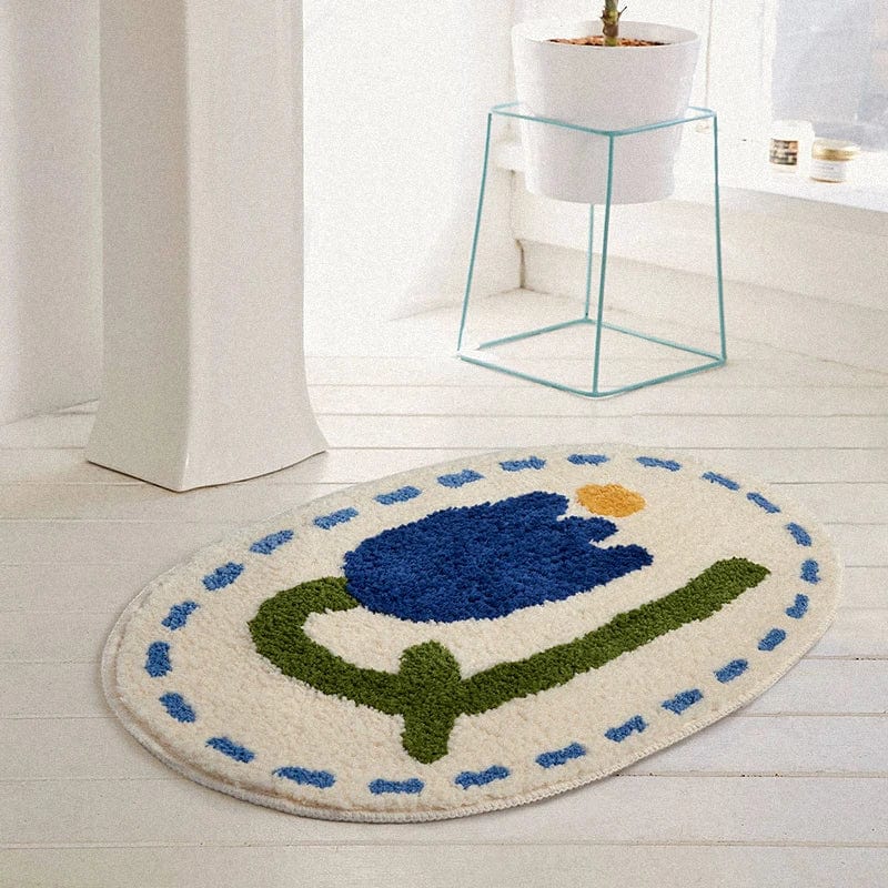 Round bath mat with blue tulip design for bathroom decor.
