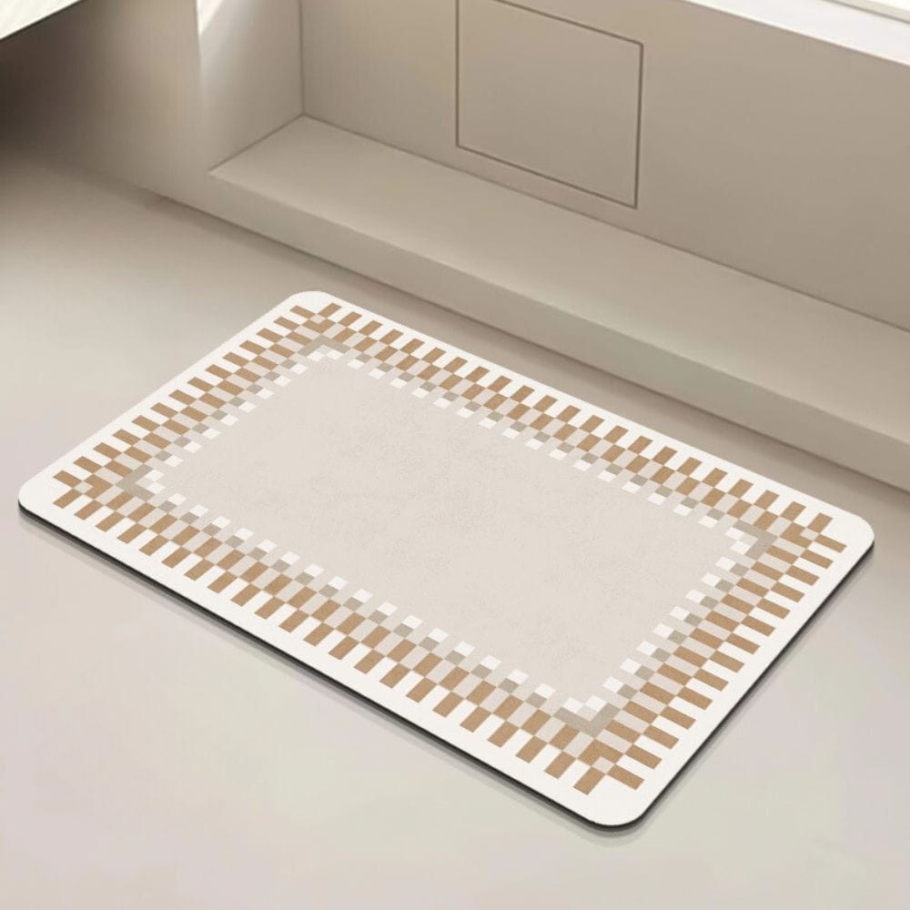 Modern beige bath mat with pixelated border design for bathroom.