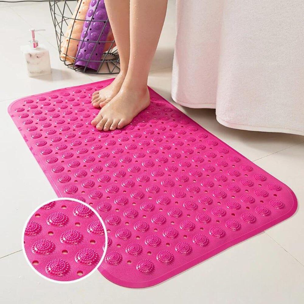 Pink textured bath mat with drainage holes for grip and dryness.
