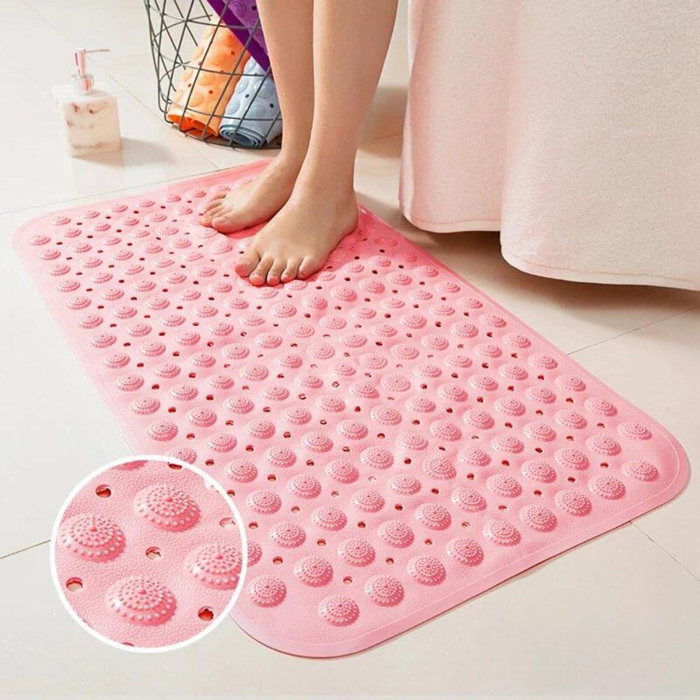 Pink textured bath mat with drainage holes for bathroom safety and comfort.
