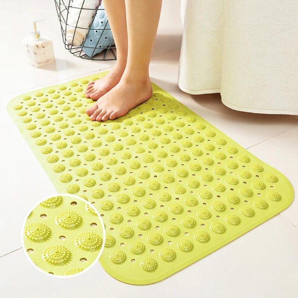 Green textured bath mat with non-slip dots for bathroom safety.