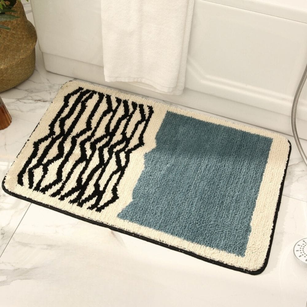 Modern zebra print bath mat with teal square design for bathroom.