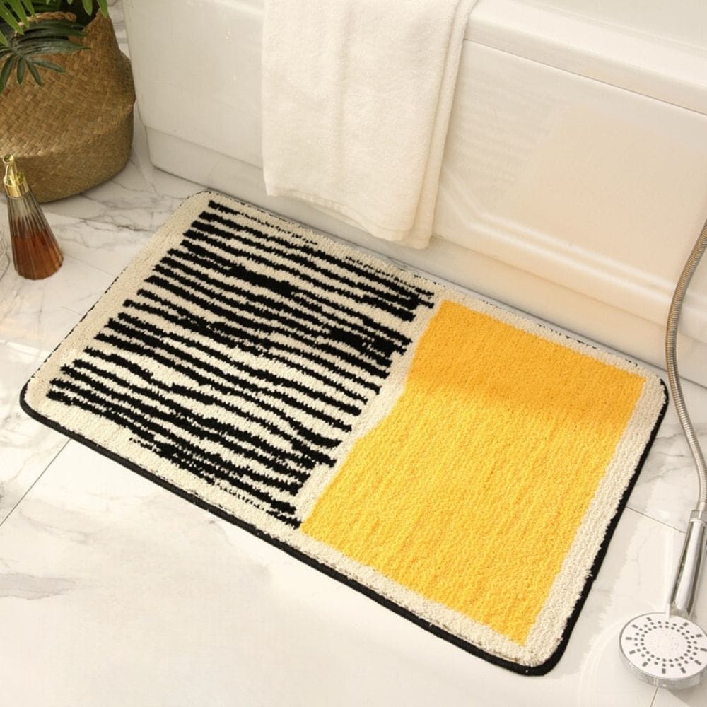 Modern black and yellow striped bath mat for stylish bathroom decor.