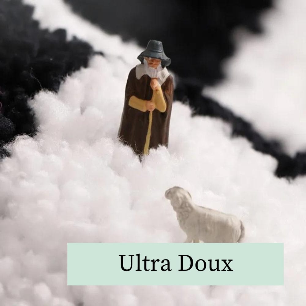 Black and white checkered bath mat with ultra soft texture and shepherd figurine.