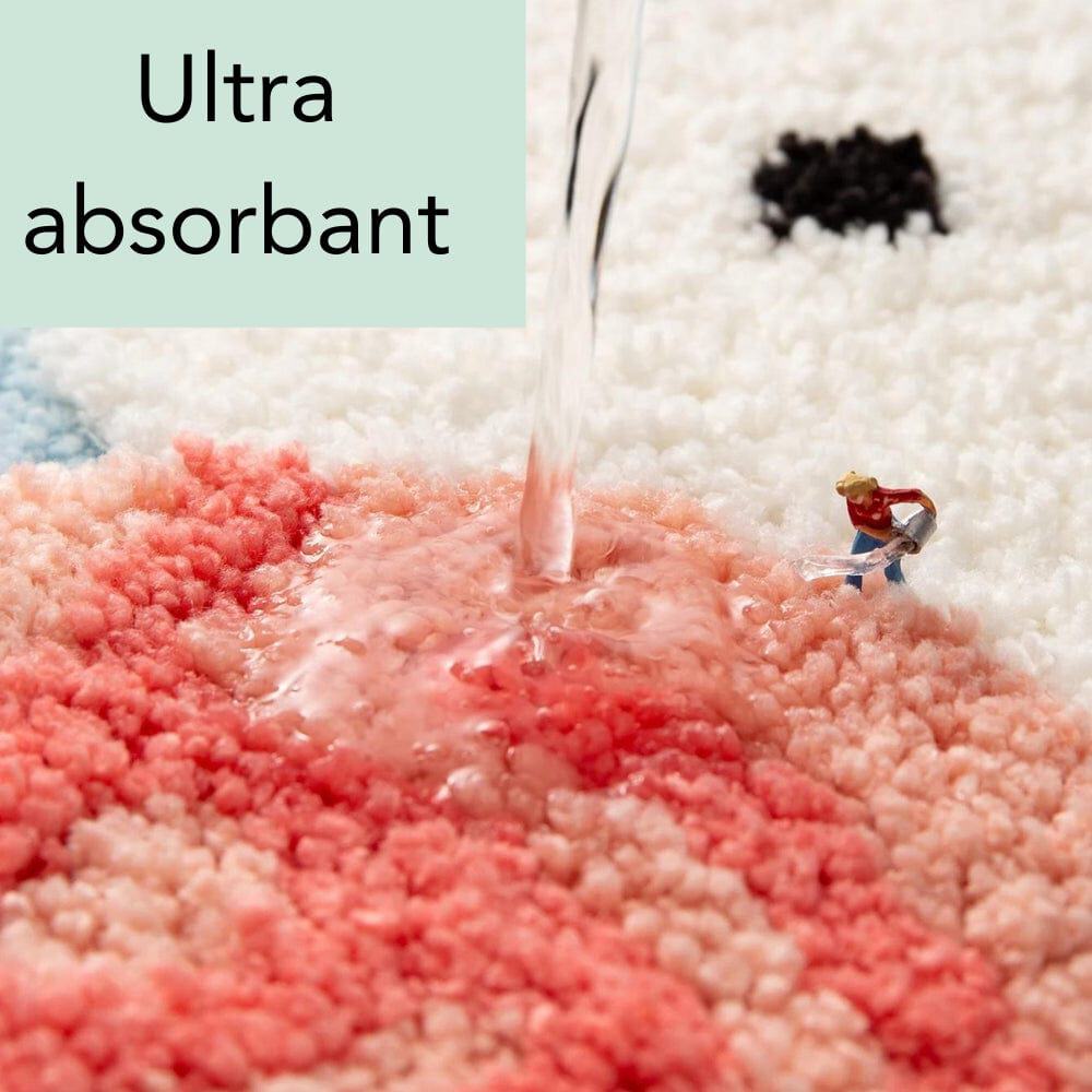 Blue Cat Bath Mat ultra absorbent, water soaking into plush surface.
