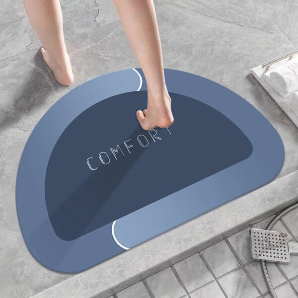 Blue gray bath mat with 'COMFORT' text, modern bathroom design.
