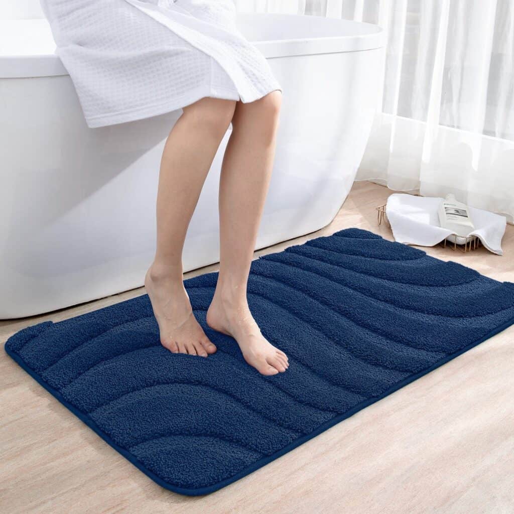 Blue non-slip bath mat with textured design for bathroom safety.