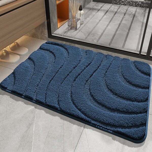 Blue non-slip bath mat with textured waves for bathroom safety and comfort.