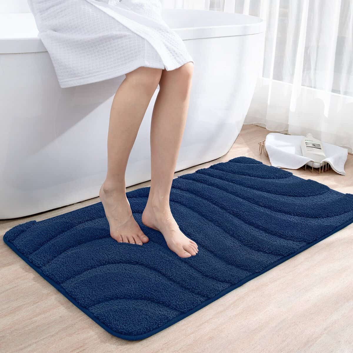 Blue non-slip bath mat with textured design for bathroom safety.