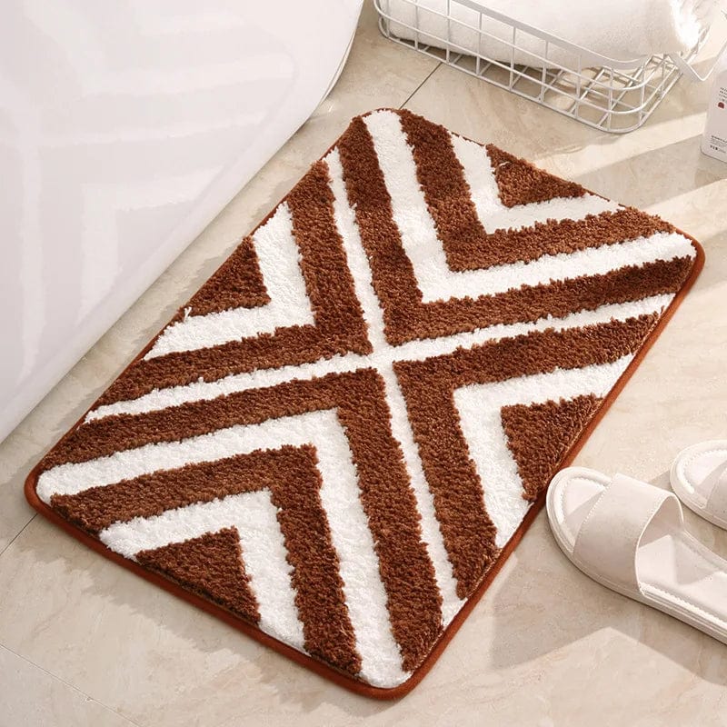 Brown and white chevron striped bath mat for bathroom.