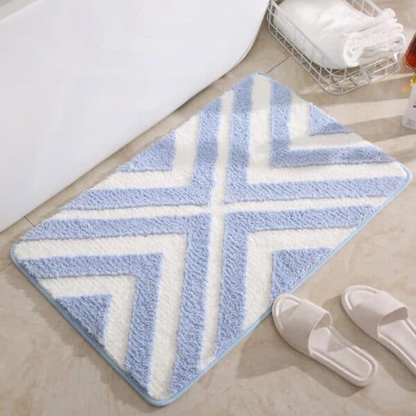 Blue striped bath mat with chevron pattern for bathroom.