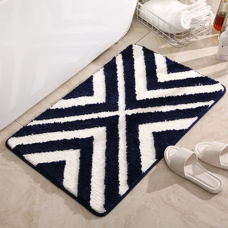 Blue and white striped bath mat with chevron pattern for bathroom.