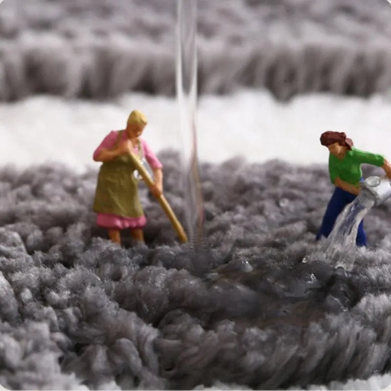 Blue striped bath mat with playful miniature figures washing.