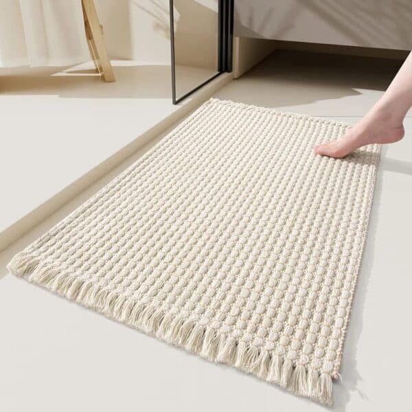 Boho style bath mat with fringe, cozy bathroom rug.