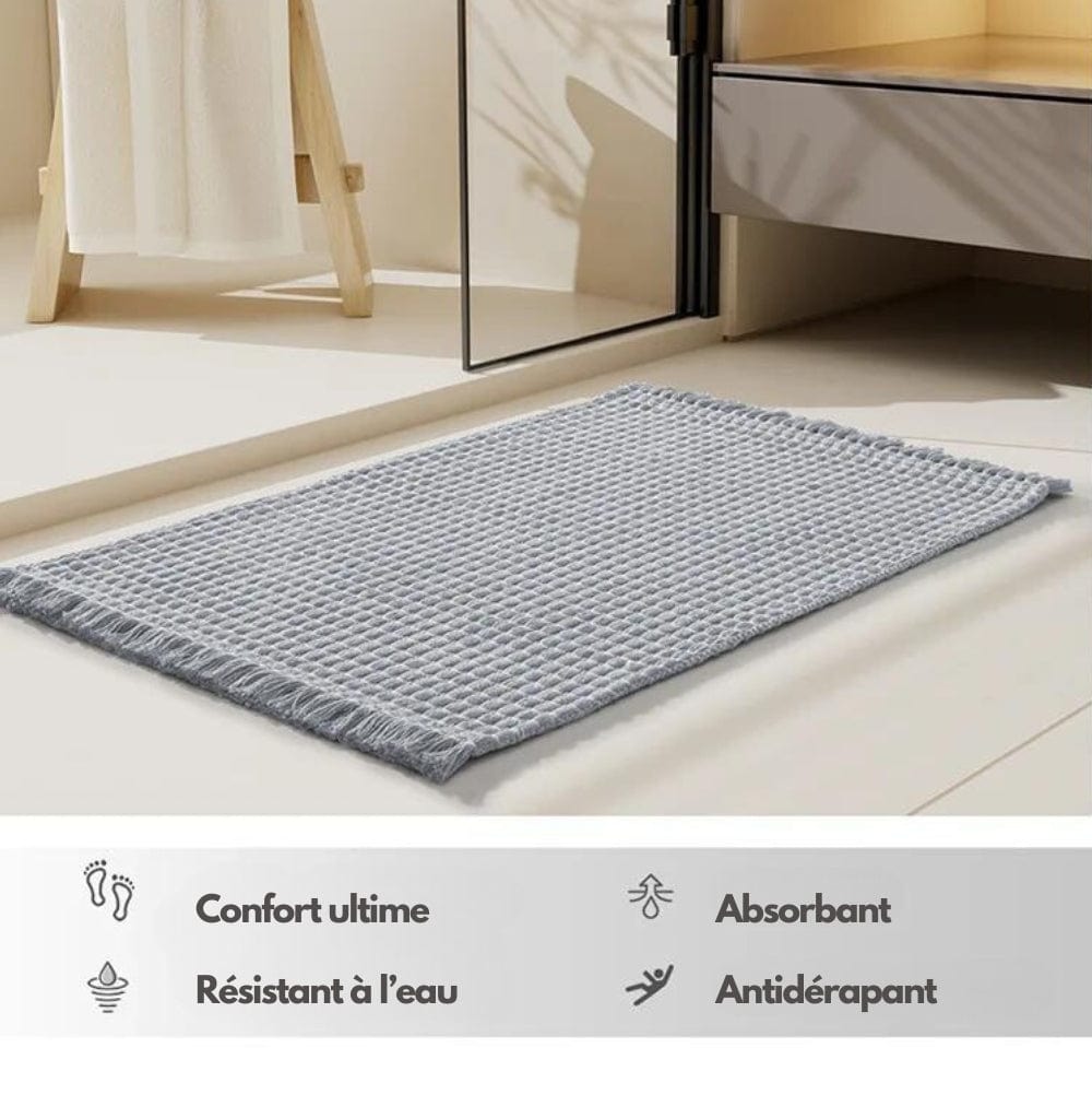 Boho style grey bath mat with fringed edges, absorbent and non-slip.