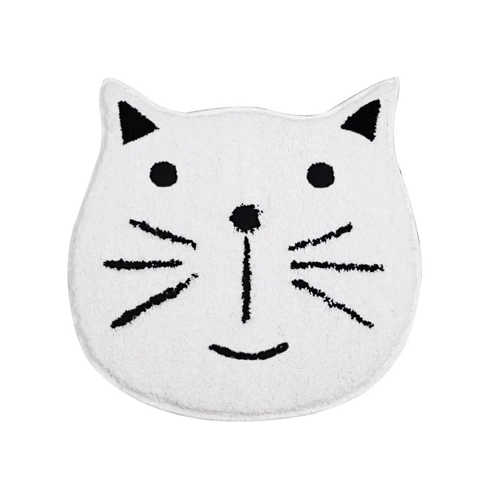 White cat face bath mat with black whiskers and eyes.