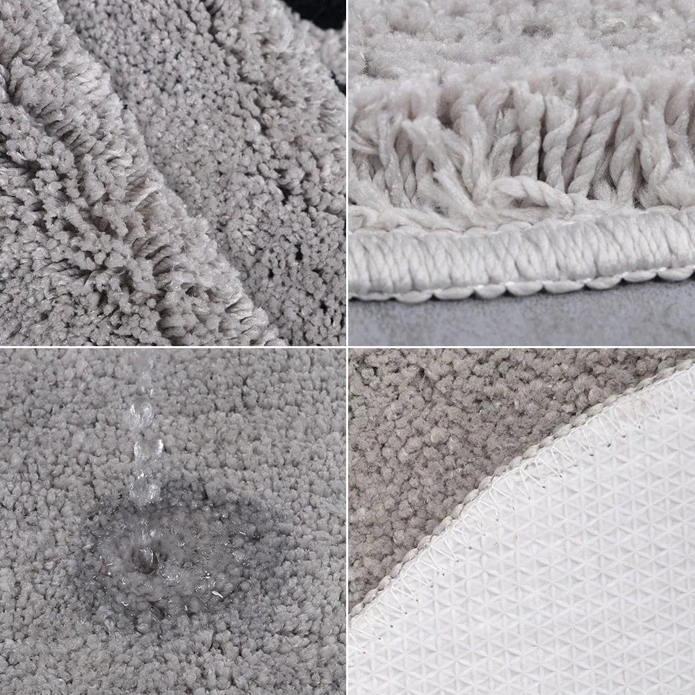 Grey plush bath mat with textured backing and water-resistant design.