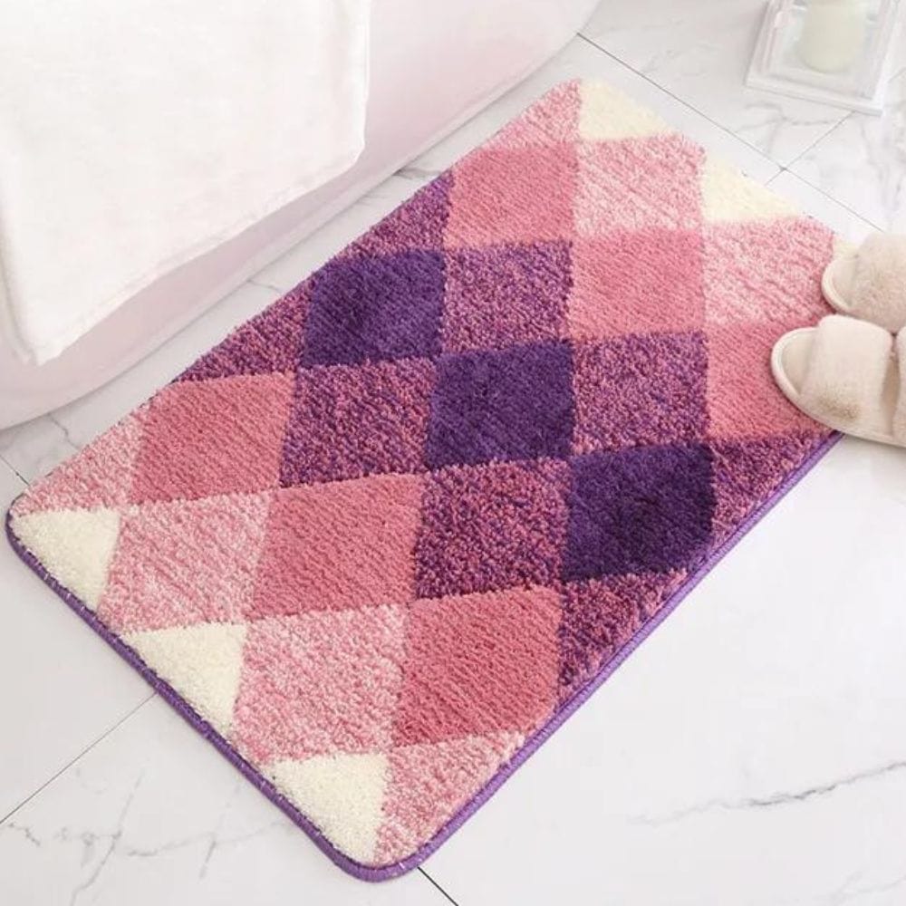 Pink and purple checked bath mat with fluffy texture.