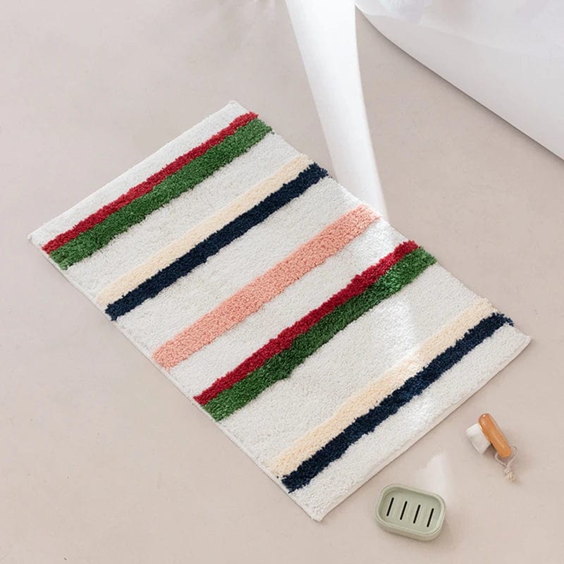 Colourful striped bath mat with red, green, navy and peach accents.