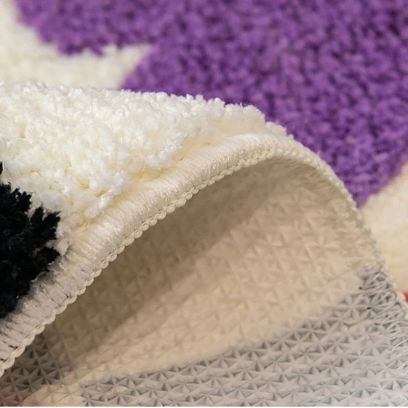 Colourful bath mat close-up showing plush texture and patterned underside.