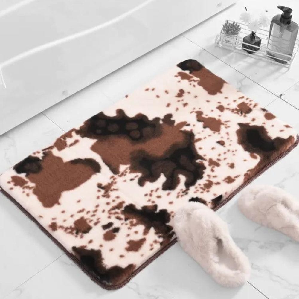 Cow print fluffy bath mat for bathroom comfort and style.