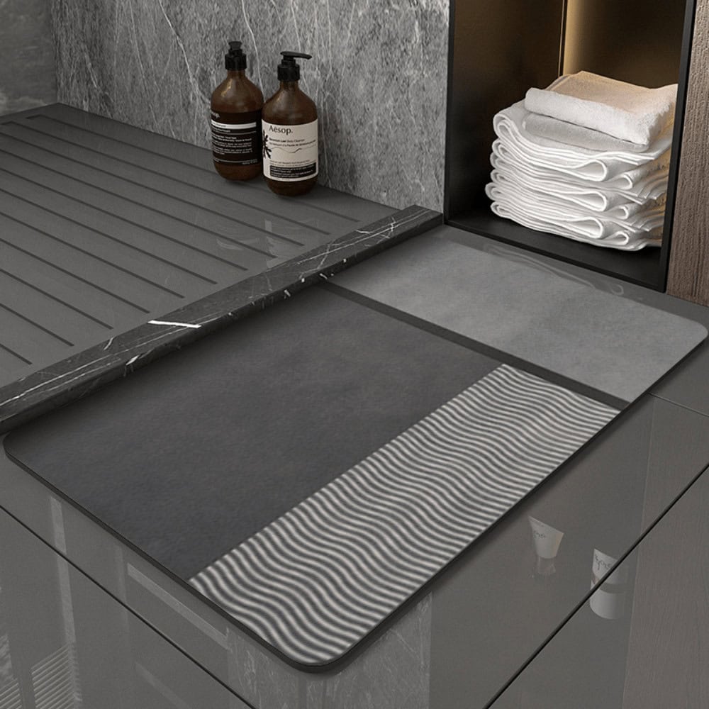 Grey diatomite bath mat with wave pattern for modern bathroom.