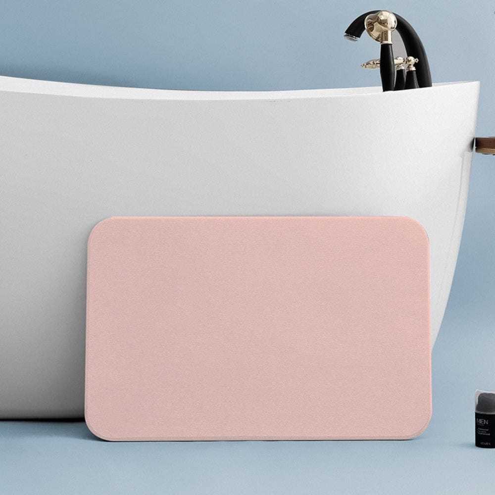 Pink diatomite bath mat for bathroom, soft absorbent, non-slip, modern design.