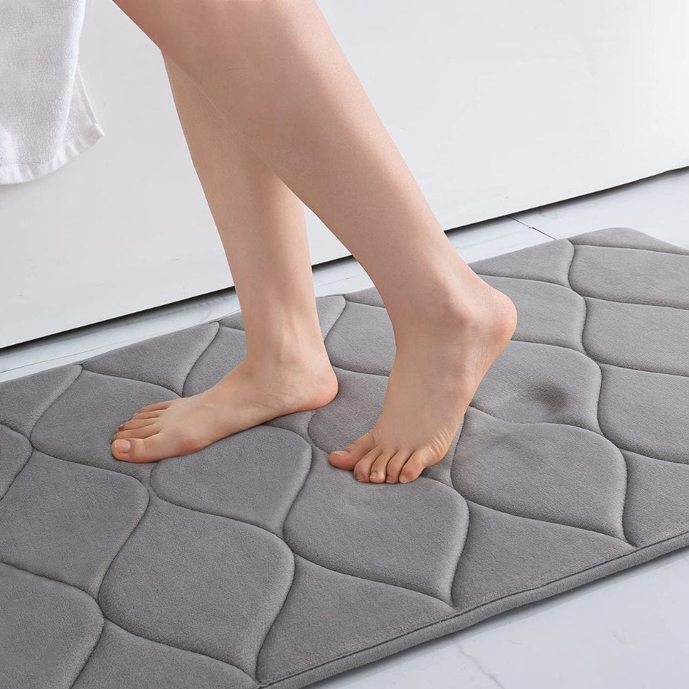 Extra thick grey quilted bath mat for comfort and warmth.