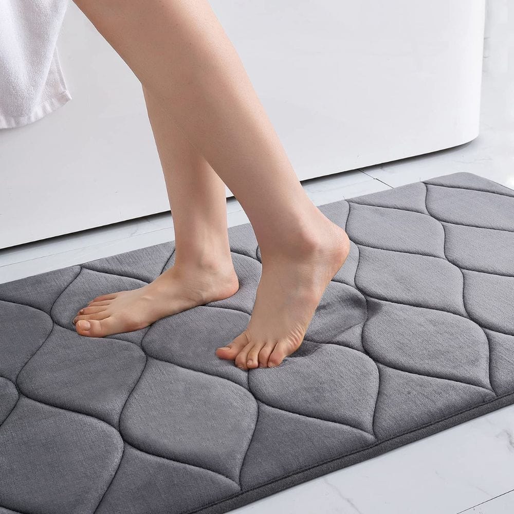 Extra thick grey quilted bath mat for comfort and grip.