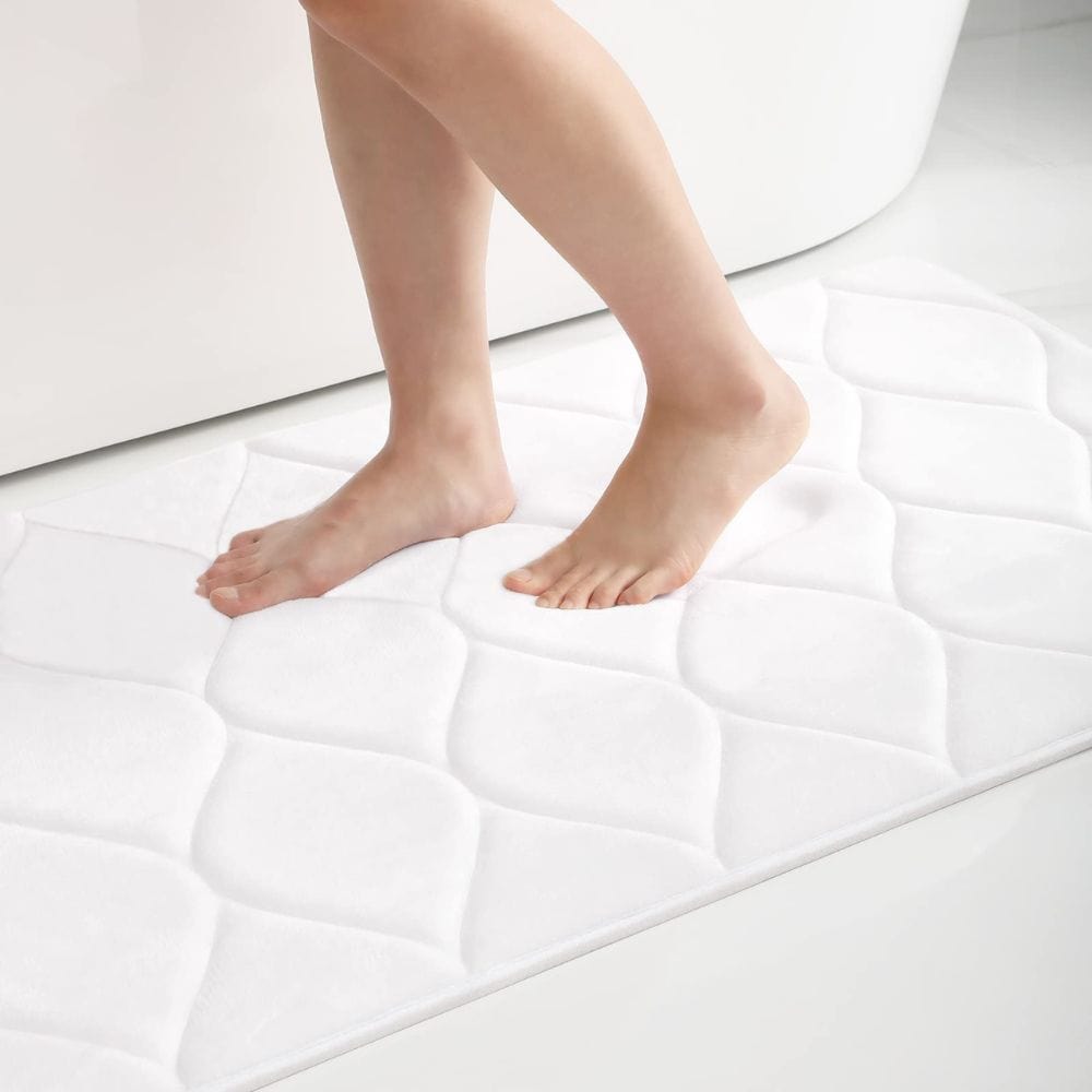 Extra thick white bath mat with quilted design for comfort and grip.