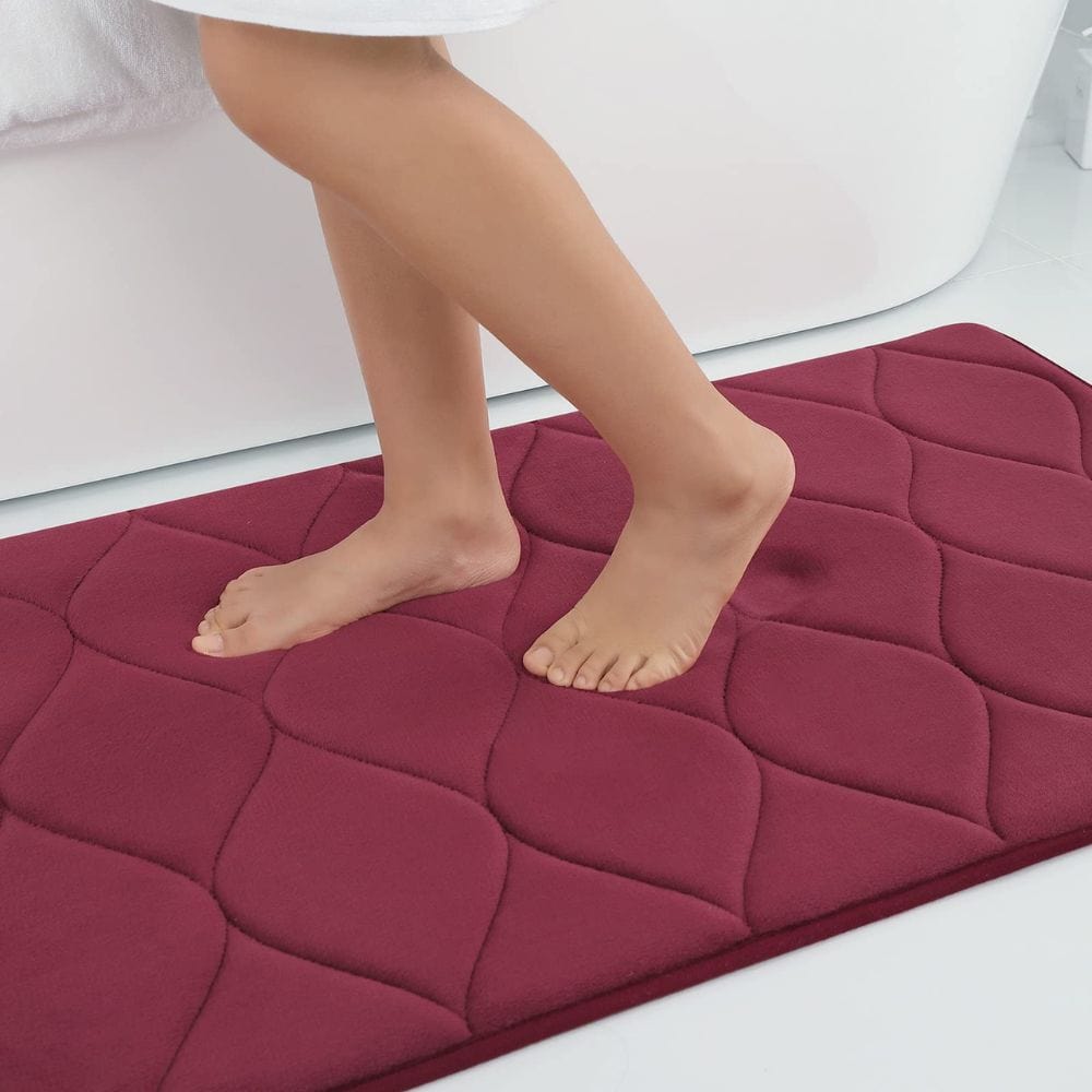 Extra thick burgundy bath mat with quilted design for comfort and grip.