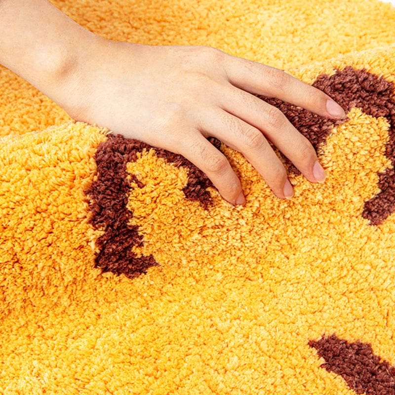 Fish-shaped bath mat with soft plush texture for cozy bathroom comfort.