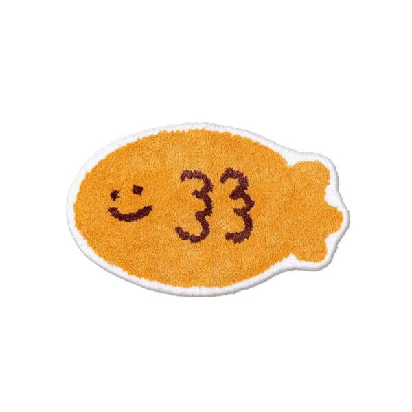 Funny fish-shaped bath mat with smiley face and number 33.